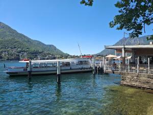 a boat is docked at a dock on the water at Apartment Centre nhe in Lecco