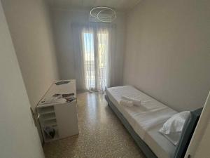 a small bedroom with a bed and a window at Asteras City Apartments in Chios