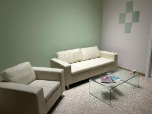 a living room with two couches and a coffee table at Asteras City Apartments in Chios