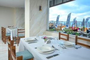 a table in a restaurant with a view of the ocean at Hostmark Blue Beach Hotel in Marsa Matruh