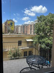 a balcony with a table and a view of buildings at La Dimora del Re in Rome