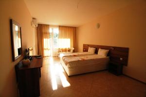 a bedroom with a large bed in a room at Hotel Marant in Sozopol
