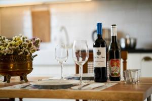 two bottles of wine and two glasses on a table at Sparrow Sintra Nest in Sintra