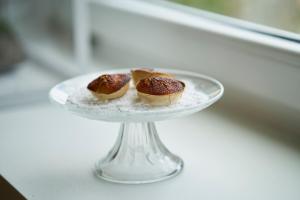 two donuts on a glass plate on a table at Sparrow Sintra Nest in Sintra