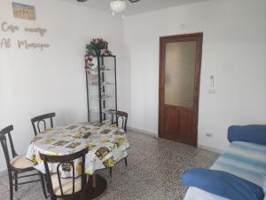 a dining room with a table and chairs and a door at Al Municipio in Sperlinga