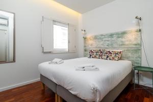 Postel nebo postele na pokoji v ubytování Oporto Riverside Rooftop