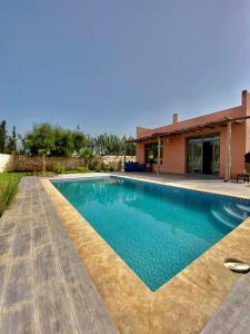 a swimming pool in front of a house at Villa famille in Ida Ougourd