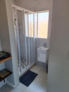 a bathroom with a shower and a sink at 30 on Dijon room 1 in Gqeberha