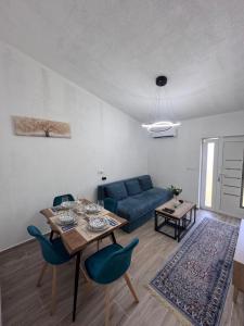a living room with a blue couch and a table at Rajkovic Stay Bukovik in Bukovik