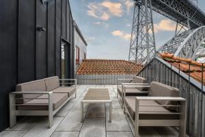 a balcony with chairs and tables on a building at GuestReady - Douro Nest Apartments in Bandeira