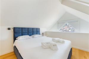 a bedroom with a large bed with towels on it at GuestReady - Douro Nest Apartments in Bandeira +92 photos