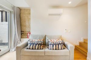 a living room with a couch and a window at GuestReady - Douro Nest Apartments in Bandeira