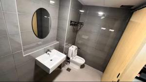a bathroom with a sink and a toilet and a mirror at Budget stay in Kajang town near to MRT in Kajang