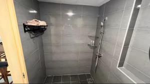 a bathroom with a shower with gray tiles at Budget stay in Kajang town near to MRT in Kajang
