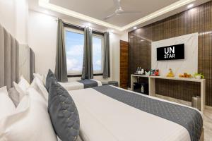 a hotel room with a bed and a television at Hotel U-N Star - Walk in from New Delhi Railway Station and Connaught Place in New Delhi