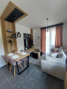 a living room with a couch and a table at Apartman Šišarka Dva Divčibare in Divčibare