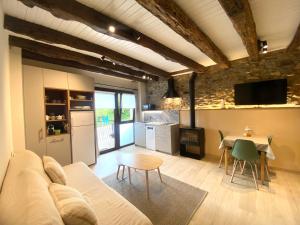a living room with a couch and a table at Country loft Zarautz- San Sebastián in Aia +24 photos