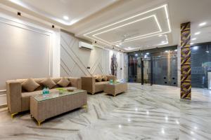 a living room with couches and tables in a room at Hotel U-N Star - Walk in from New Delhi Railway Station and Connaught Place in New Delhi