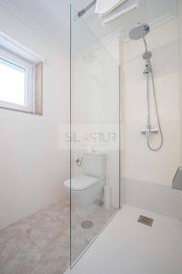 a bathroom with a glass shower and a toilet at La Xarrina By Silastur in Llanes