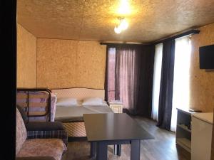 a small room with a bed and a table at Syuzn Resort in Goris