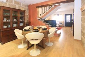 a dining room with a table and white chairs at Casa Marron Boutique Home in Benissa