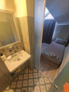 a bathroom with a sink and a mirror and a bed at Teo Han Suites Center Plovdiv in Plovdiv +27 photos