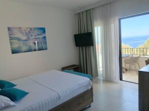 a bedroom with a bed and a view of a balcony at REZEVICI BOUTIQUE VILLA in Petrovac na Moru