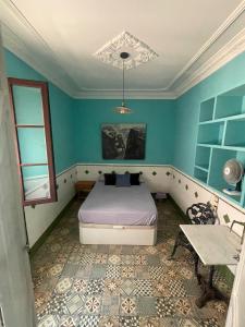 a bedroom with a bed and a table in it at Fabrica de Sueños in Gandía