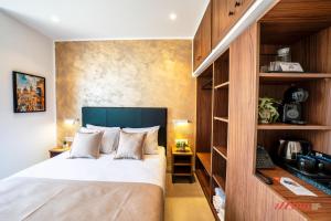 a bedroom with a bed and a book shelf at Ta' Guzeppi Boutique Stays Near St Thomas Bay in Il-Maħsel