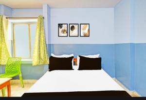 Un dormitorio azul con una cama y una silla. en MOONLIGHT Inn, en Hyderabad