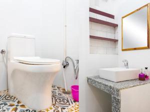 a bathroom with a white toilet and a sink at Raahee Homestay in Varanasi +25 photos