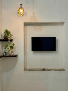 a flat screen tv hanging on a wall at Raahee Homestay in Varanasi