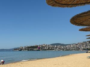 a view of a beach with a city in the background at Wtite Sea 2 in Kavála