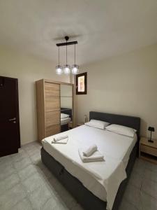 a bedroom with a large bed with two towels on it at Endless Blu Apartments in Pyrgadikia