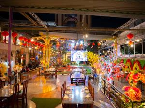 a restaurant with tables and chairs and lights at hotel NGỌC QUÍ in Ho Chi Minh City