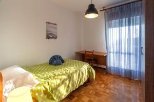 ein Schlafzimmer mit einem Bett, einem Schreibtisch und einem Fenster in der Unterkunft Hermanos Pinzón in Zamora