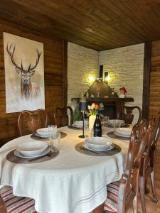 a table with plates and a deer painting on the wall at Stara hiža pod Okićem in Jastrebarsko