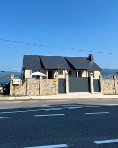 a house sitting on the side of a street at Chancelas b in Combarro