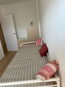 a bed with two pillows on it in a room at Paseo del Tolon 10 in La Granja de San Ildefonso