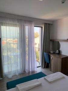 a hotel room with a bed and a large window at REZEVICI BOUTIQUE VILLA in Petrovac na Moru
