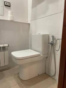 a white toilet in a bathroom with a shower at Pensión Capital de Galicia in Santiago de Compostela