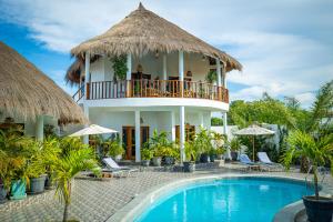 a villa with a swimming pool and a balcony at TinJaLa Lodge in Brufut