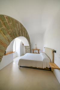 a bedroom with a bed and a brick wall at Tenuta Calitto wine resort e spa in Forio d'Ischia +127 photos