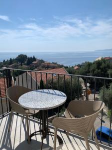 a table and chairs on a balcony with a view at REZEVICI BOUTIQUE VILLA in Petrovac na Moru
