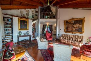 a living room with a couch and chairs and a table at Villa DAutore in Alba +26 photos