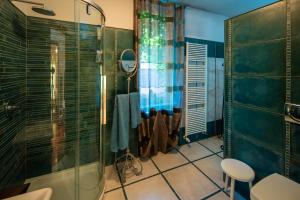 a bathroom with a shower and a glass shower stall at Villa DAutore in Alba