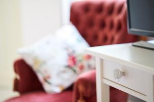 a red chair with a pillow next to a table at Sparrow Sintra Nest in Sintra