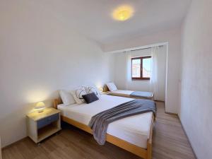 Postel nebo postele na pokoji v ubytování Apartment Dunato I