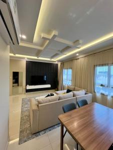 a living room with a couch and a table at لافانتا للشقق المخدومه - LAVANTA Hotel in Al Khobar +52 photos