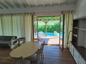 a living room with a table and chairs and a patio at Villa Casablanca with private pool in Lozenets